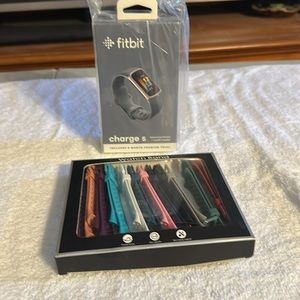 Fitbit charge 5 new in box. Never opened steel blue band 12 extra bands